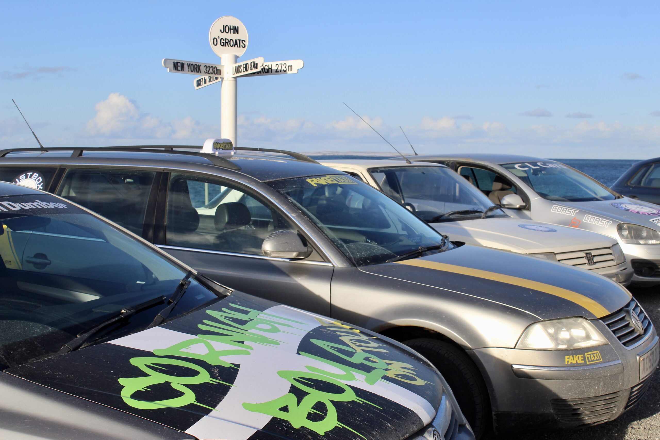 Image of cars around John o'Groats sign post